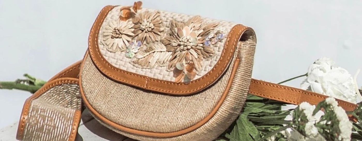 A cross-body bag embroidered with flowers using raffia ribbon & sequins.