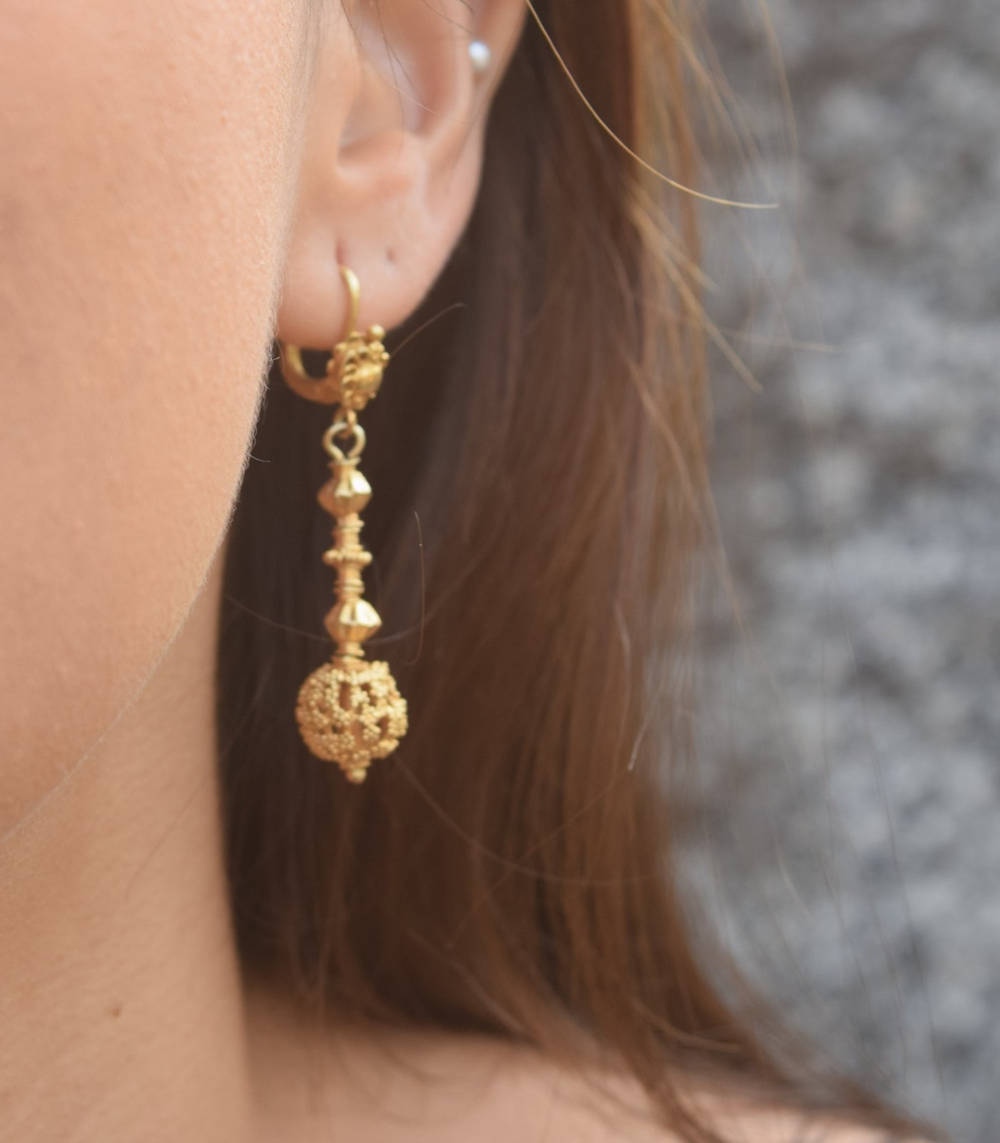 Amami Tambourine Dangle Earrings on a model close-up
