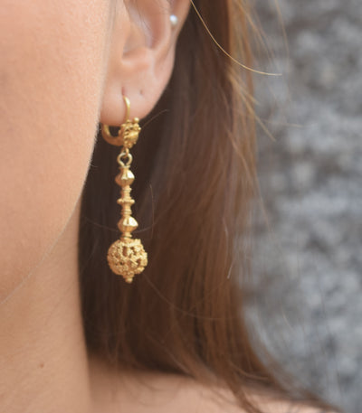 Amami Tambourine Dangle Earrings on a model close-up